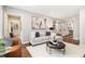 Comfortable living room with a sectional sofa, hardwood floors, and view to the kitchen at 522 Stell Rd, Woodstock, GA 30188