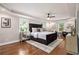 Spacious main bedroom featuring hardwood floors, a tray ceiling, and neutral walls at 522 Stell Rd, Woodstock, GA 30188