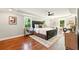 Bright main bedroom featuring hardwood floors, neutral walls, and a large window with backyard view at 522 Stell Rd, Woodstock, GA 30188