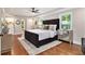 Large main bedroom with hardwood floors, a tray ceiling, and a decorative rug at 522 Stell Rd, Woodstock, GA 30188