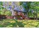 A spacious, fenced backyard with a wooden deck, offers privacy and room for outdoor activities at 142 Wellspring Pt, Hiram, GA 30141