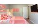Staged bedroom featuring a bed, pink decor, and ample lighting at 142 Wellspring Pt, Hiram, GA 30141