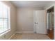 Neutral bedroom with a closet, a window that brings in natural light, and an entry door at 142 Wellspring Pt, Hiram, GA 30141