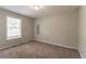 Well-lit bedroom with carpet flooring and a window at 142 Wellspring Pt, Hiram, GA 30141