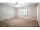 Spacious bedroom with carpet flooring and a large window at 142 Wellspring Pt, Hiram, GA 30141