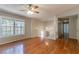 Large living room with hardwood floors and views to a hallway and staircase at 142 Wellspring Pt, Hiram, GA 30141