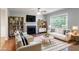 Stylishly staged living room with modern furniture and a cozy fireplace at 142 Wellspring Pt, Hiram, GA 30141