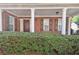 Inviting front porch with classic white columns and well-maintained landscaping at 1885 Hickory Station Cir, Snellville, GA 30078