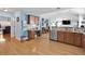 Open kitchen with wood cabinets, granite counters, stainless appliances, and a breakfast bar at 1885 Hickory Station Cir, Snellville, GA 30078