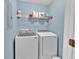 Laundry area with washer, dryer and wire shelving with plenty of storage space at 1885 Hickory Station Cir, Snellville, GA 30078