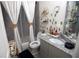 Tastefully decorated bathroom featuring a granite countertop vanity, decorative shelves, and shower at 5663 Eternal Dr, Atlanta, GA 30349