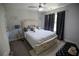 Cozy bedroom features a comfortable bed, neutral decor, a ceiling fan, and ample natural light at 5663 Eternal Dr, Atlanta, GA 30349
