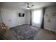 Cozy bedroom with a ceiling fan, a large window with curtains, and a soft, shag rug at 5663 Eternal Dr, Atlanta, GA 30349
