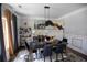 Elegant dining room with modern lighting, dark accents, neutral colors, and large window at 5663 Eternal Dr, Atlanta, GA 30349