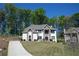 Charming two-story home features a brick and stone facade, complemented by mature trees and a well-manicured lawn at 5663 Eternal Dr, Atlanta, GA 30349