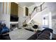 Living room with fireplace, lots of light, staircase, and decoratively painted walls at 5663 Eternal Dr, Atlanta, GA 30349