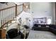 Stunning staircase leading to a living room with a high ceiling and open concept kitchen in the background at 5663 Eternal Dr, Atlanta, GA 30349
