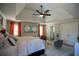 Spacious main bedroom with a tray ceiling, lots of pillows, and multiple mirrors on the wall at 5663 Eternal Dr, Atlanta, GA 30349