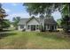 Exterior back of home featuring screened in porch with large backyard at 609 Ashton Manor Dr, Loganville, GA 30052