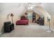 Large upstairs bedroom with a slanted ceiling, neutral carpet and paint, and space for a bed and office at 609 Ashton Manor Dr, Loganville, GA 30052