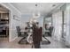 Elegant dining room with tile floors, modern chandelier and glass table at 609 Ashton Manor Dr, Loganville, GA 30052