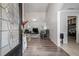 View from the front door into the well-lit living room with vaulted ceilings and hardwood floors at 609 Ashton Manor Dr, Loganville, GA 30052