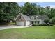 Charming home with brick and siding, a two-car garage and well-manicured lawn at 609 Ashton Manor Dr, Loganville, GA 30052