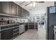 Spacious kitchen with stainless steel appliances, dark cabinets and granite countertops at 609 Ashton Manor Dr, Loganville, GA 30052
