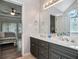 Bathroom featuring a double vanity, tile floors, and an open view to the main bedroom at 609 Ashton Manor Dr, Loganville, GA 30052