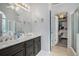 Main bathroom with double vanity, tile floors and access to the closet and a separate tub at 609 Ashton Manor Dr, Loganville, GA 30052