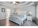 Bright main bedroom featuring hardwood floors, a ceiling fan, and a view to the bath area at 609 Ashton Manor Dr, Loganville, GA 30052