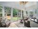 The sunroom features large windows with an exit to the outside deck and backyard at 609 Ashton Manor Dr, Loganville, GA 30052