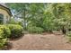Charming backyard featuring lush greenery, a stone pathway, and a cozy bench at 1285 Rivershyre Pkwy, Lawrenceville, GA 30043