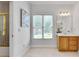 Bathroom featuring a single vanity, framed mirror, and a window with natural light at 1285 Rivershyre Pkwy, Lawrenceville, GA 30043