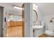 Bathroom and kitchen combination featuring stainless steel appliances, wooden cabinets, and a sink and toilet at 1285 Rivershyre Pkwy, Lawrenceville, GA 30043