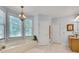 Bathroom featuring a soaking tub, beautiful light fixture, and a window with natural light at 1285 Rivershyre Pkwy, Lawrenceville, GA 30043