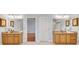 Bathroom featuring dual vanities, granite counters, framed mirrors, and tile flooring at 1285 Rivershyre Pkwy, Lawrenceville, GA 30043