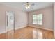 Bedroom featuring hardwood floors, a ceiling fan, and a large window with natural light at 1285 Rivershyre Pkwy, Lawrenceville, GA 30043