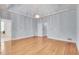 Bright bedroom featuring hardwood floors, neutral walls, tray ceiling, and an elegant chandelier at 1285 Rivershyre Pkwy, Lawrenceville, GA 30043
