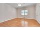 Bedroom featuring hardwood floors, a window for natural light, and a clean, neutral color scheme at 1285 Rivershyre Pkwy, Lawrenceville, GA 30043