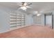 Large bonus room with carpet flooring, built-in shelving, and open layout, ideal for entertaining at 1285 Rivershyre Pkwy, Lawrenceville, GA 30043
