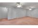 Large bonus room features carpet flooring, multiple doors, and ceiling fans for optimal comfort at 1285 Rivershyre Pkwy, Lawrenceville, GA 30043