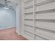 Bonus room with carpet flooring featuring built-in shelving and access to additional living spaces at 1285 Rivershyre Pkwy, Lawrenceville, GA 30043