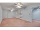 Spacious bonus room features carpet flooring, built-in shelving, and dual ceiling fans at 1285 Rivershyre Pkwy, Lawrenceville, GA 30043