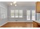 Bright dining area featuring hardwood floors, large windows, and white trim and leads to doors with access to outdoor space at 1285 Rivershyre Pkwy, Lawrenceville, GA 30043