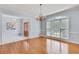 Dining room featuring shiny hardwood floors, entry to the home, a chandelier, and view of outside from large windows at 1285 Rivershyre Pkwy, Lawrenceville, GA 30043