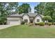 Charming single-story home featuring manicured landscaping, a two-car garage and a well-maintained lawn at 1285 Rivershyre Pkwy, Lawrenceville, GA 30043
