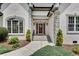 Elegant entryway featuring a classic front door, decorative wreath, and manicured landscaping at 1285 Rivershyre Pkwy, Lawrenceville, GA 30043