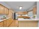 Modern kitchen with stainless steel appliances, ample counter space, and wooden cabinets at 1285 Rivershyre Pkwy, Lawrenceville, GA 30043