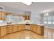Well-lit kitchen with wood cabinets, countertops, and hardwood floors at 1285 Rivershyre Pkwy, Lawrenceville, GA 30043
